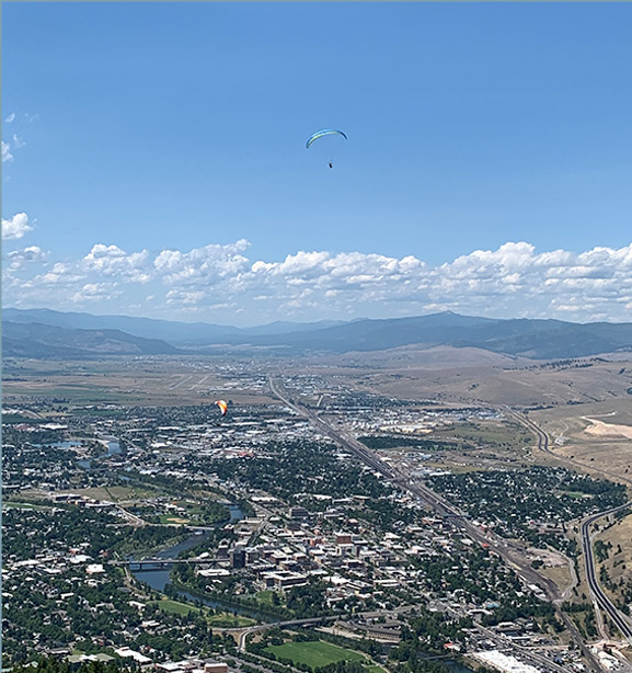 Photo of Missoula, Montana on top of Mount Sentinel looking over the city and watching paraglider pilots